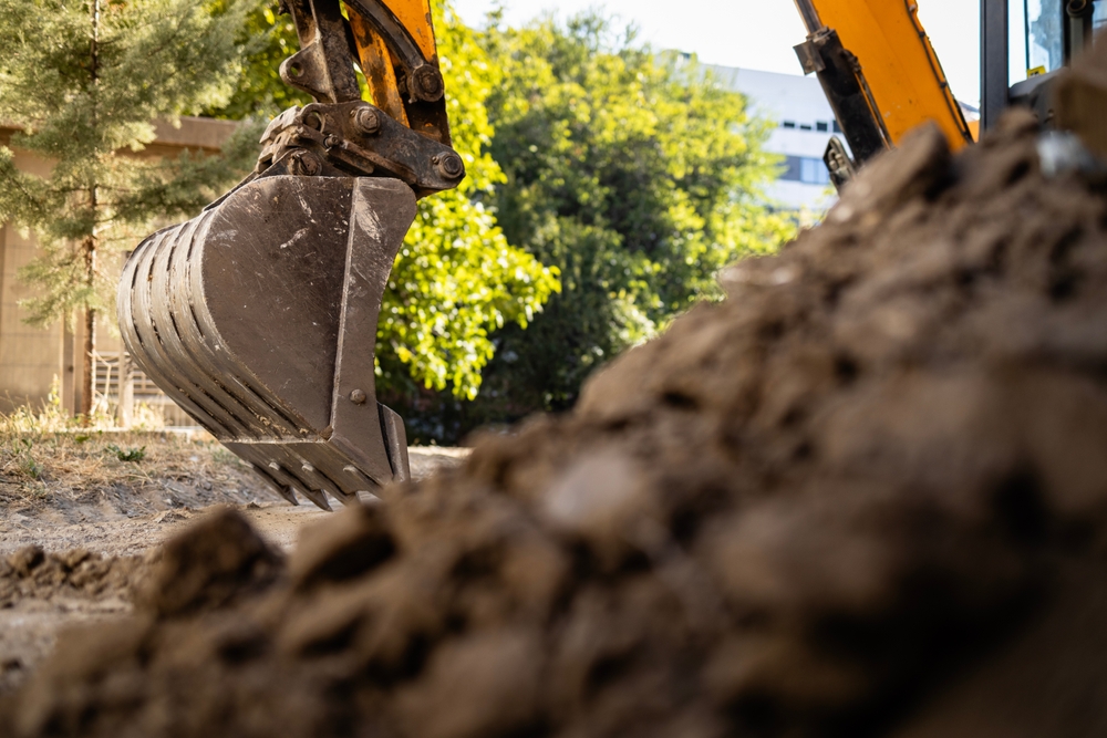 excavator digging up soil after an oil tank leak