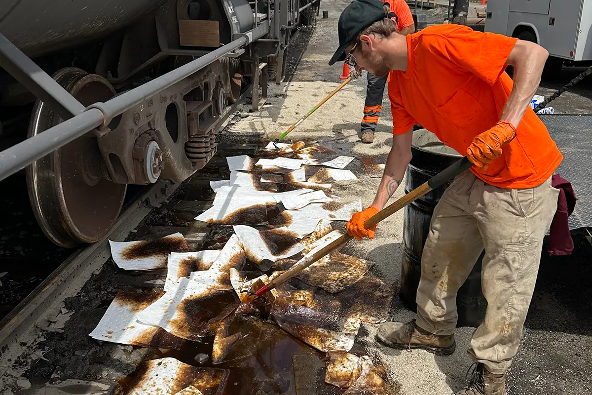 JnJ Environmental team cleaning up an oil spill near a train